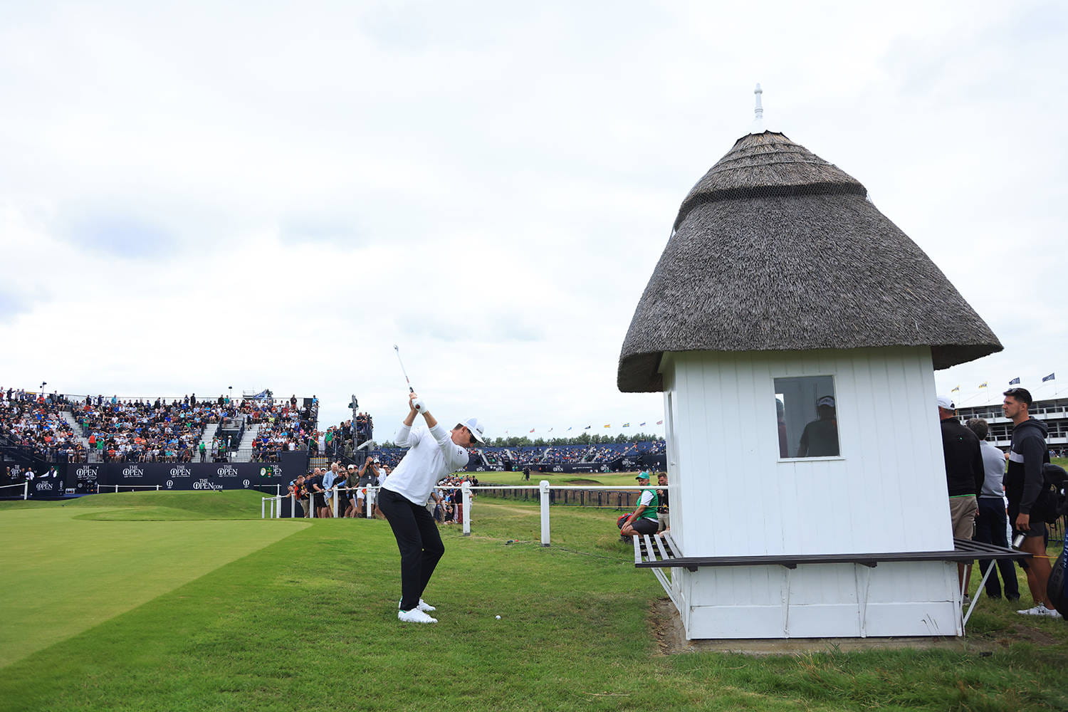 Justin Rose playing a shot next to the Starter's Hut
